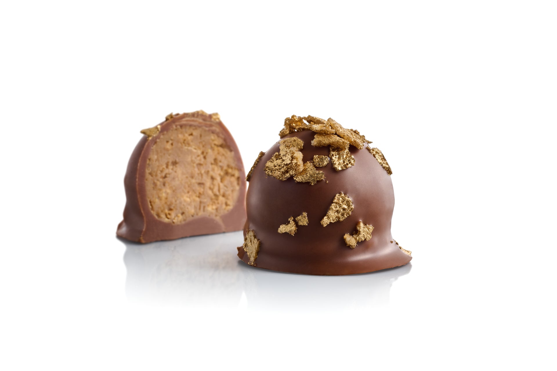 Les bonbons chocolate bonbons, milk chocolate with hazelnut and gold leaves